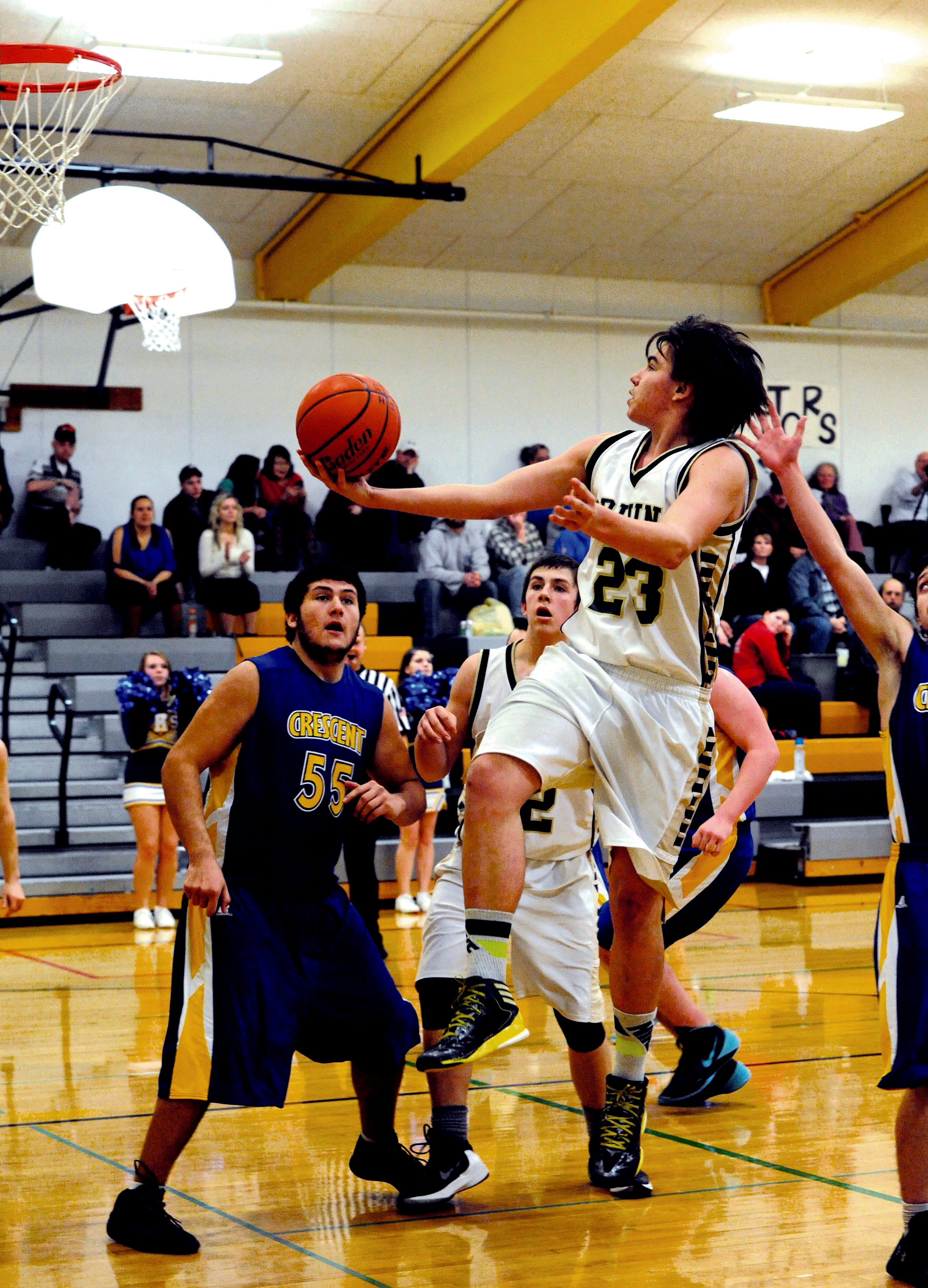 Clallam Bay senior Dakota Cowdrey (23) scores against Crescent's Wyatt McNeese (55) as Cowdrey's teammate Ryan McCoy closes in. The Bruins begin the postseason tonight at Port Angeles High School. (Lonnie Archibald/for Peninsula Daily News)