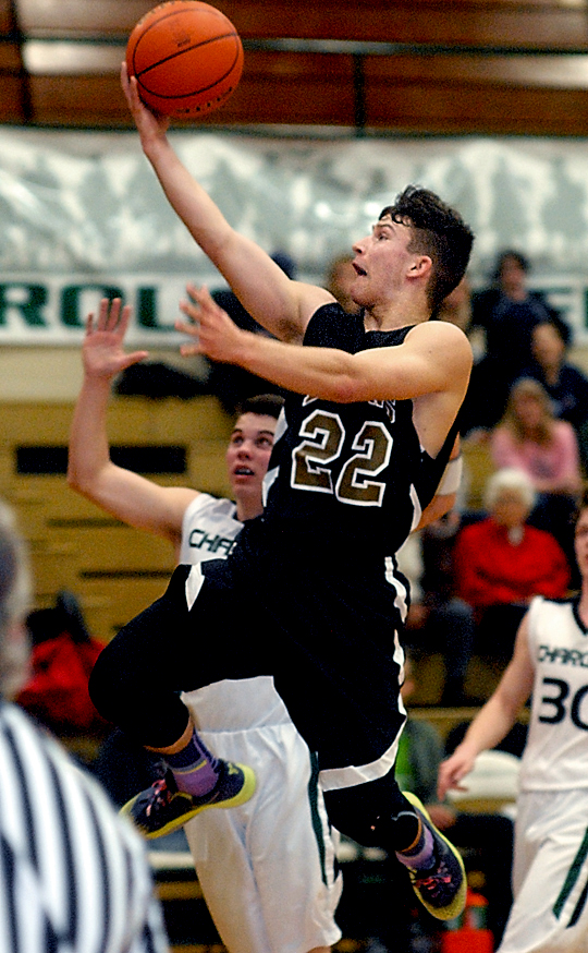 Clallam Bay's Clayton Willis slips past Shoreline Christian's Nate Monillas for a layup. (Keith Thorpe/Peninsula Daily News)