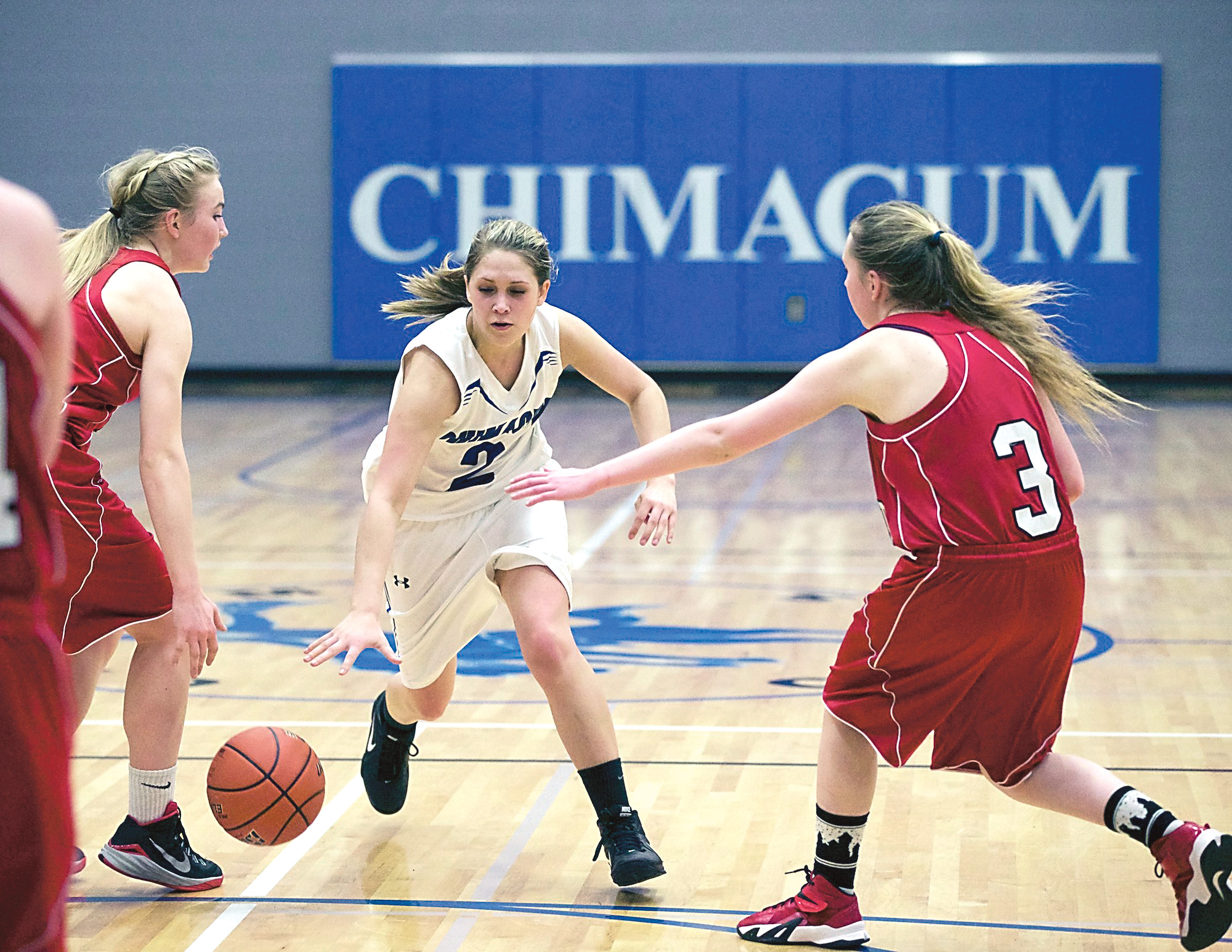 Chimacum's Kiersten Snyder (2) dribbles between Port Townsend's Kaitlyn Meek