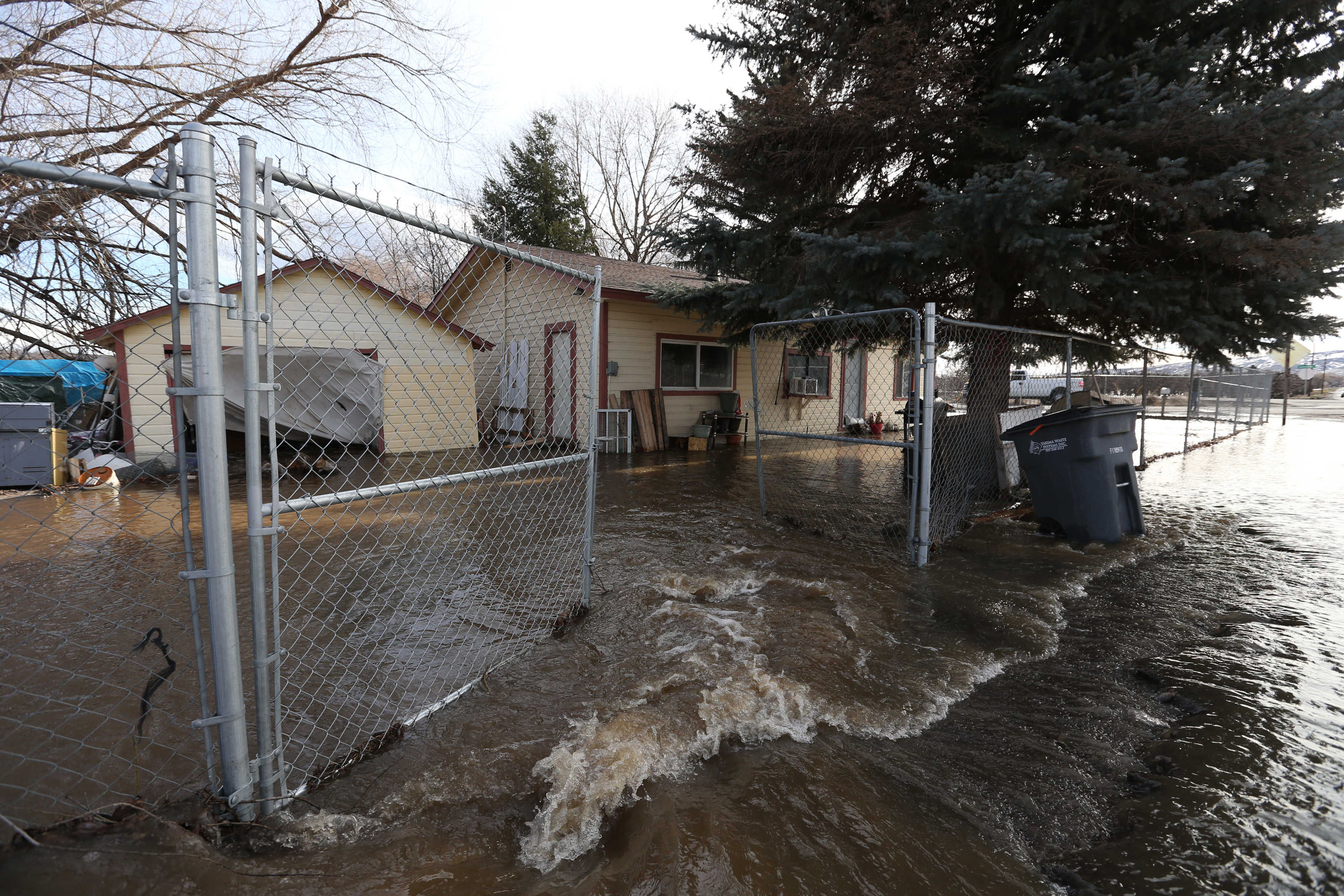 Water floods a home in Tieton. A Presidents Day storm brought record rainfall to the Pacific Northwest and sent rivers overflowing their banks in Western Washington on Tuesday. (Sofia Jaramillo/Yakima Herald-Republic via AP)