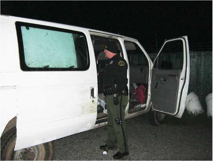 Clallam County Sheriff's Deputy Don Kitchen recovers property from the stolen van. (Sgt. Randy Pieper/Clallam County Sheriff's Office)