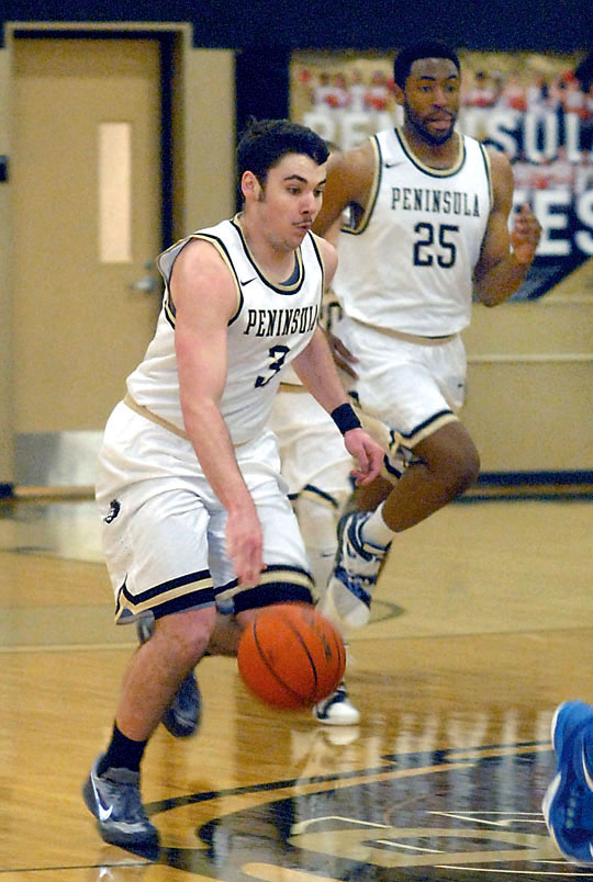 Peninsula's Ryley Callaghan brings the ball down the court during the Pirates' win over Edmonds last month. (Keith Thorpe/Peninsula Daily News)