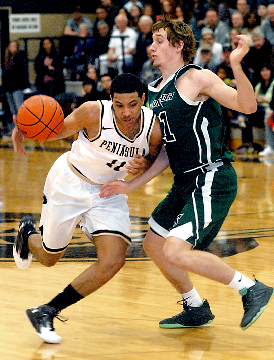 Peninsula's Deonte Dixon puts a shoulder into Chemeketa's Jack Frazier. (Keith Thorpe/Peninsula Daily News)