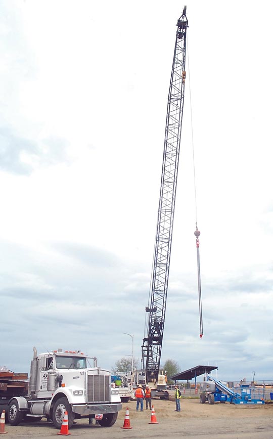 A construction crane gets prepared for use on the site of a new sewage pump station on the west end of downtown Port Angeles on Friday. (Keith Thorpe/Peninsula Daily News)