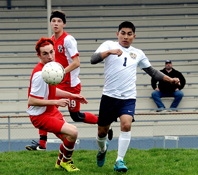Forks' Alex Martinez (1) challenges Coupeville's Garrett Compton for ball control. (Lonnie Archibald/for Peninsula Daily News)
