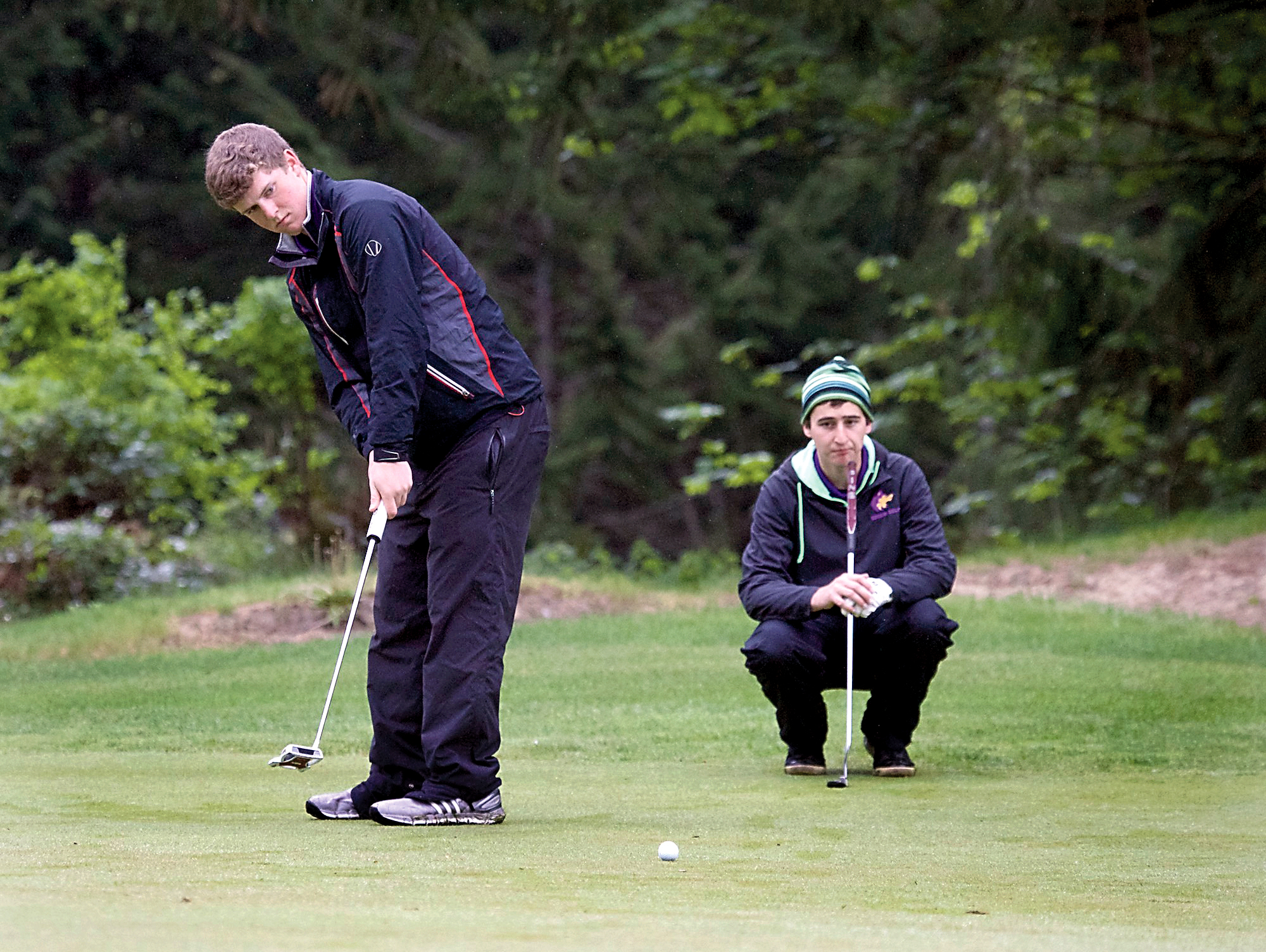 Sequim's Travis Priest watches as his playing partner