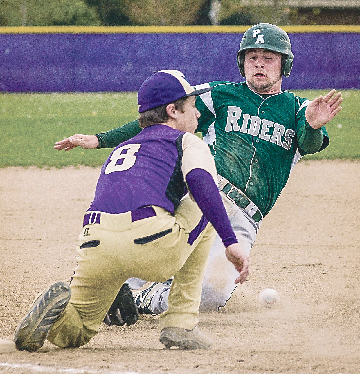 Port Angeles' Jace Bohman breaks up the throw to Sequim's Austin Hilliard and slides safely into third base during the third inning at Sequim on Wednesday. (George Leinonen/for Peninsula Daily News)