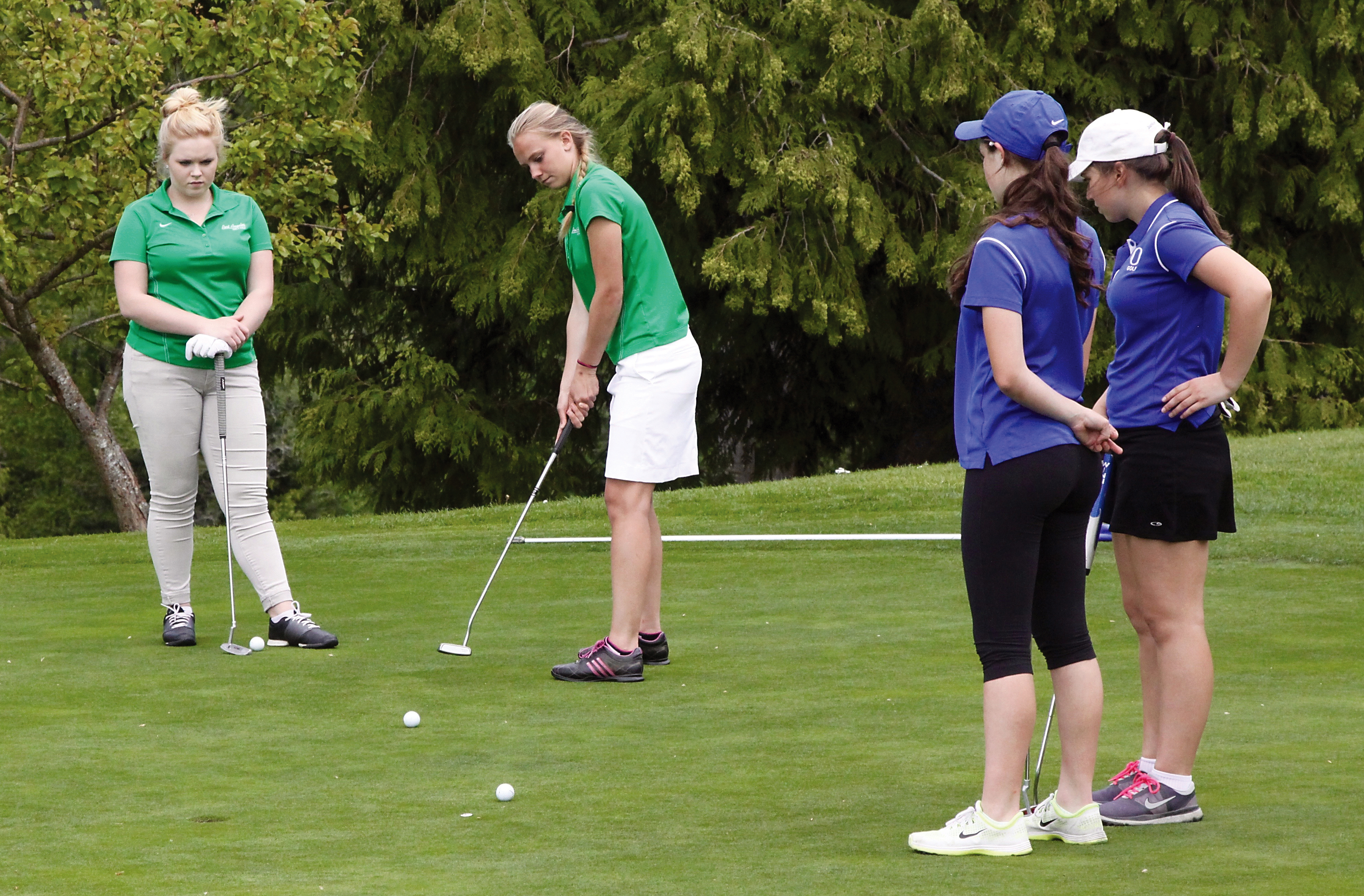 Maddie Boe of Port Angeles putts as teammate Hailey Scott