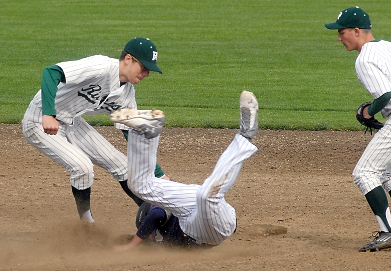 North Kitsap's Bryce Wipodarcyak goes sprawling into the second base bag after being tagged out by Port Angeles shortstop Luke Angevine