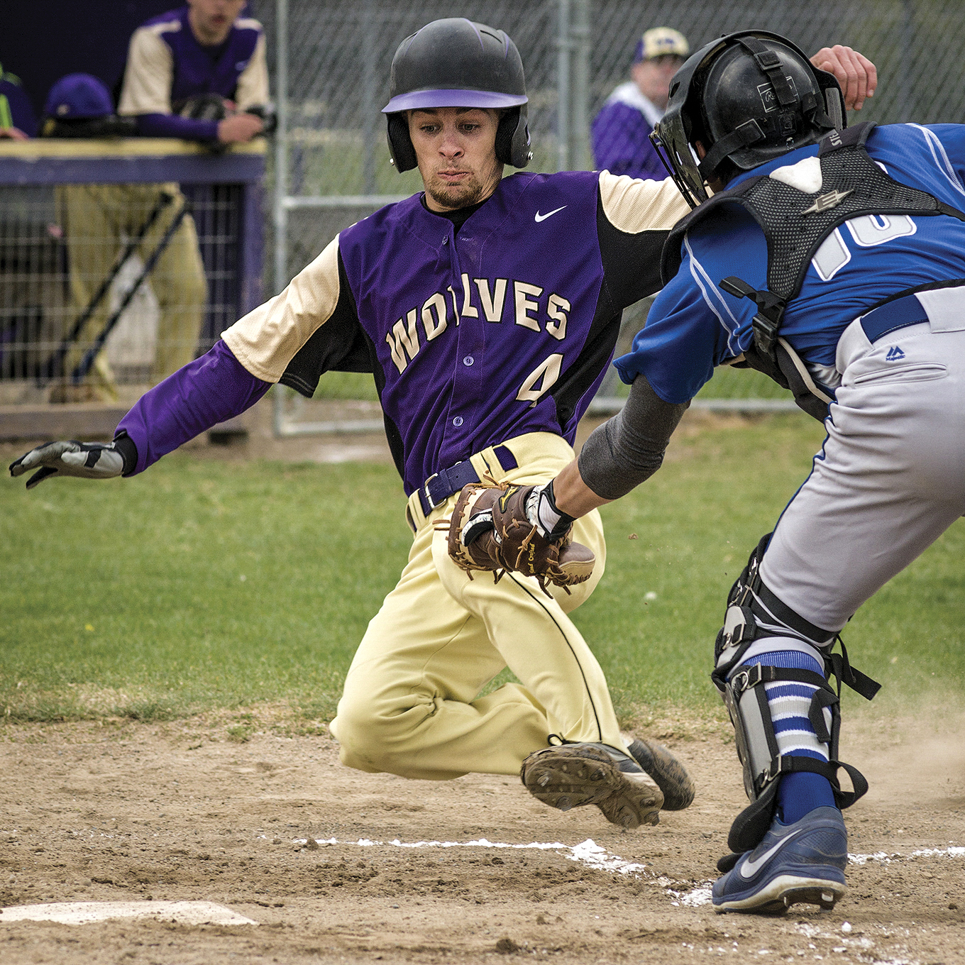 Sequim's Tanner Rhodefer slides into home plate under Olympic catcher Kylen Pereira's glove to score in the first inning. (George Leinonen/for Peninsula Daily News)