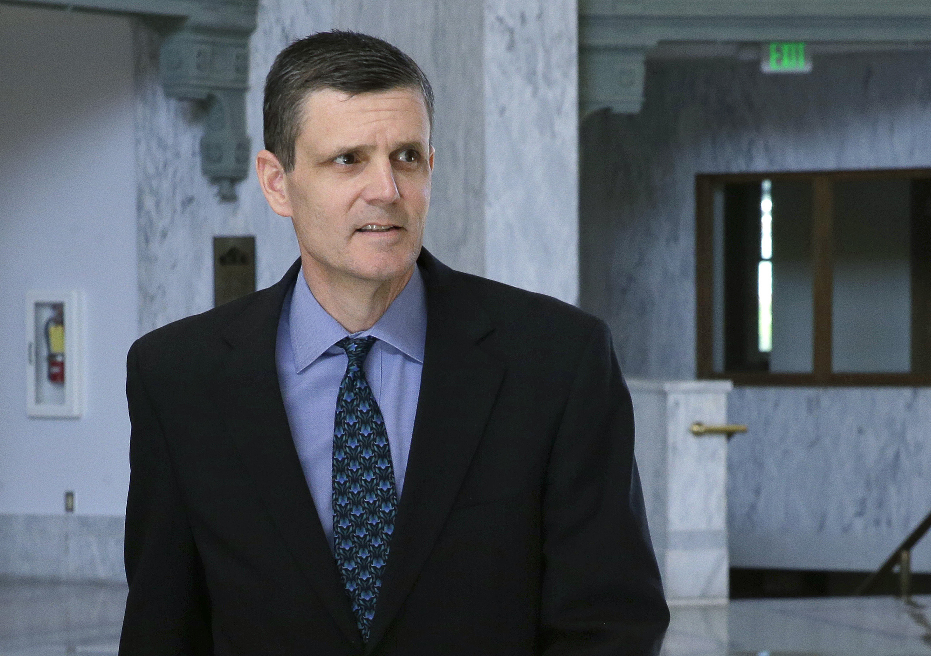 State Auditor Troy Kelley leaves the federal courthouse in Tacoma. Kelley has cut three staffers since his federal fraud trial ended with a jury deadlocked on most of the counts against him. Reasons for the firings were not clear. (The Associated Press)