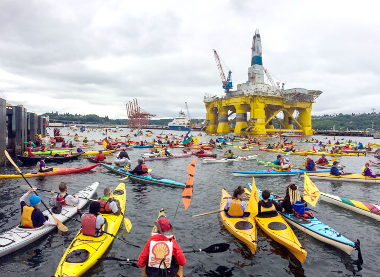 Activists in kayaks and other vessels