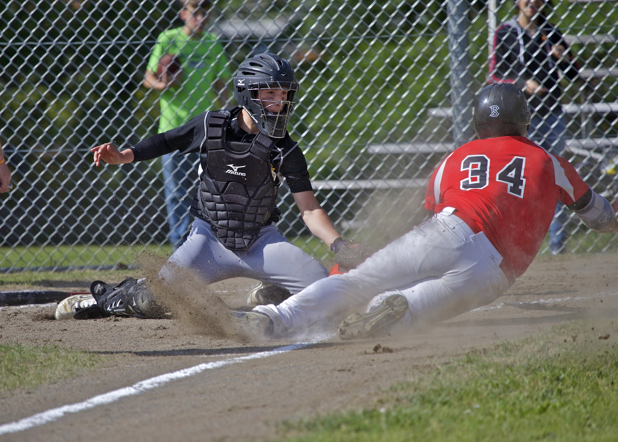Quilcene catcher A.J. Prater tags out Oakville's Alex Youcktan as he slides into home during the Class 1B Quad-District playoffs on Friday. The Rangers lost to the Acorns 8-0 on Friday and then were eliminated from the postseason with a 8-5 loss to Shoreline Christian at Muckleshoot Tribal School on Saturday. (Steve Mullensky/for Peninsula Daily News)