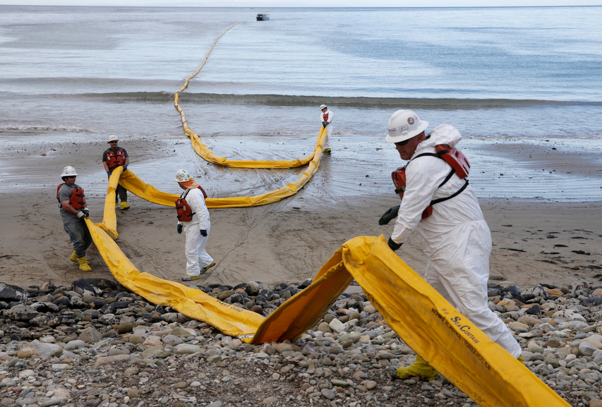 Workers prepared a containment boom Thursday after an oil spill fouled the waters off Refugio State Beach. (The Associated Press)