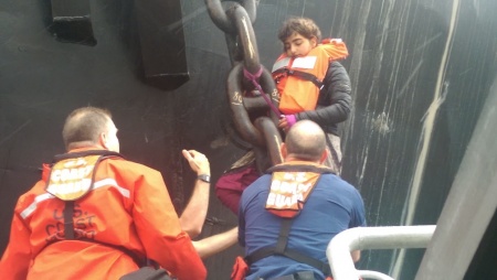 Crew members from Coast Guard Station Bellingham help activist Chiara D'Angelo get down from the anchor chain of the Arctic Challenger in the Port of Bellingham on Monday. (Coast Guard Station Bellingham)