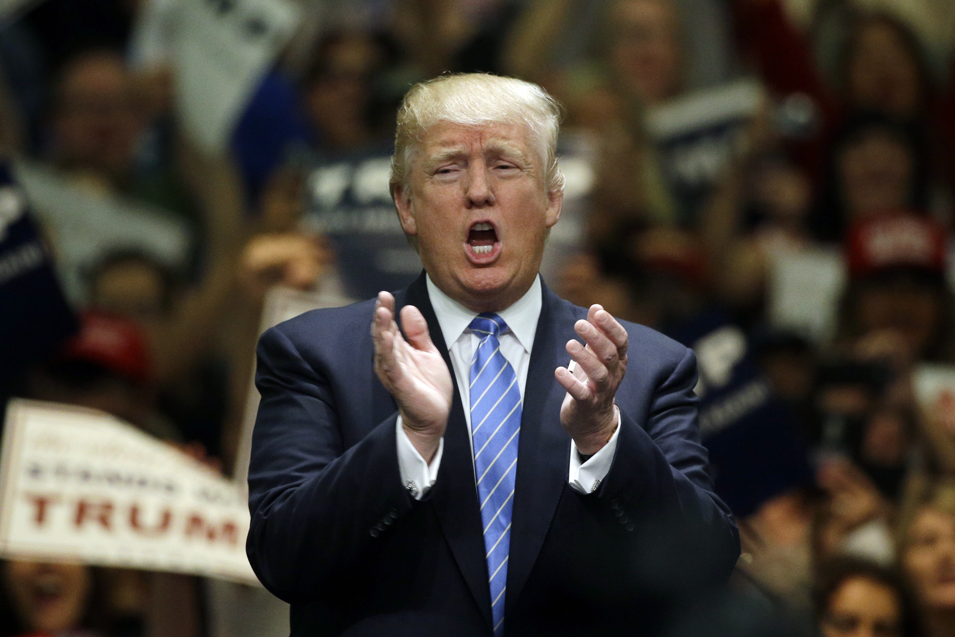 Republican presidential candidate Donald Trump applauds after singing the National Anthem during a rally at the Anaheim Convention Center on Wednesday in Anaheim