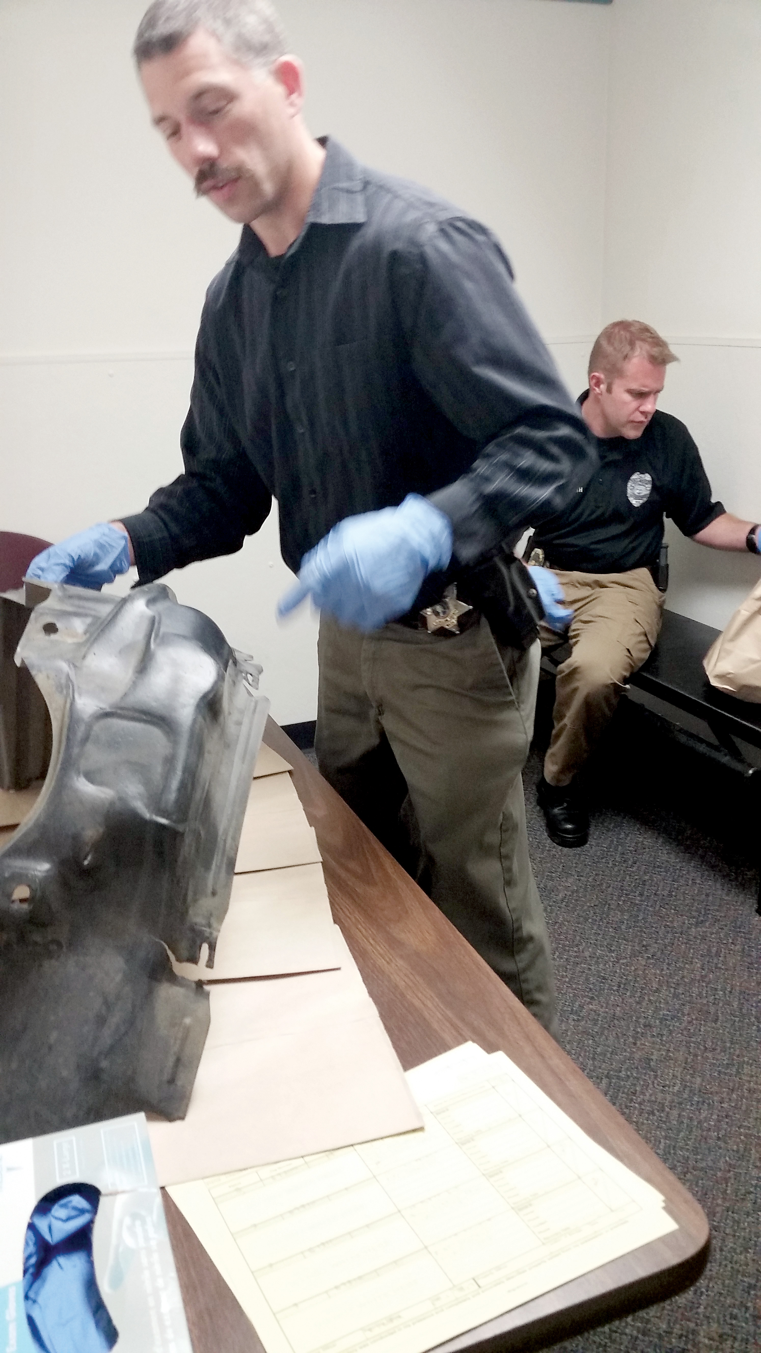 Clallam County Sheriff's Detective Josh Ley examining evidence in the fatal Port Angeles hit-and-run case. ()