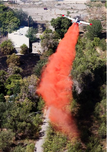A plane drops retardant on a fire Tuesday (Sept. 1) in Cottonwood Heights