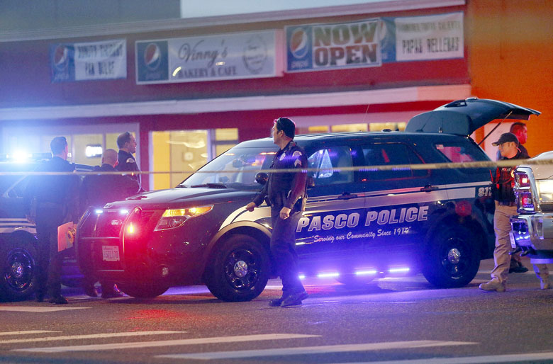 Pasco police officers investigate the scene of the shooting of Antonio Zambrano-Montes