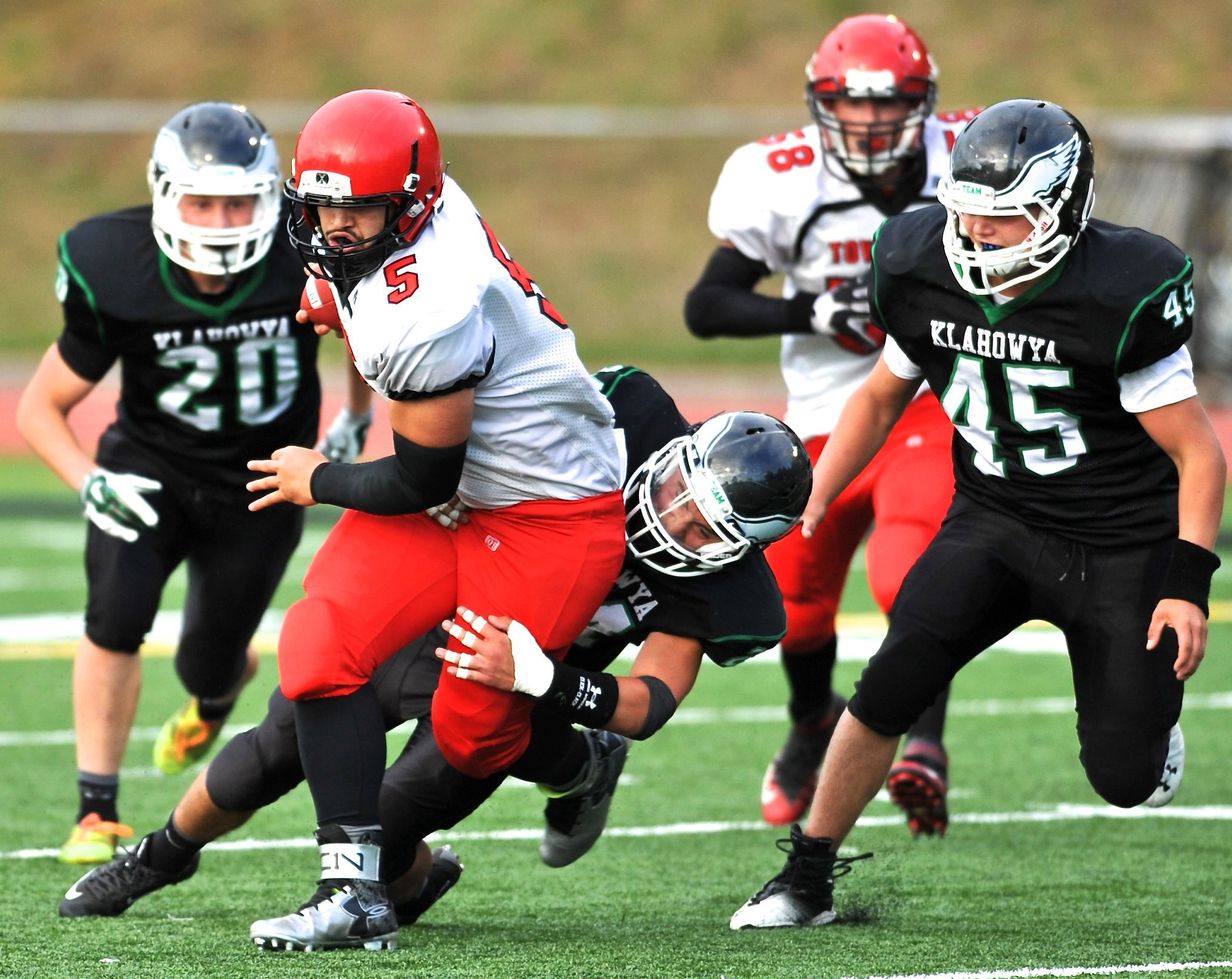 Port Townsend quarterback David Sua (5) runs through a tackle by Klahowya's Lucas Weaver as Jacob Sargent (20) and Tyler Vandergriff (45) close in. Jeff Halstead/for Peninsula Daily News