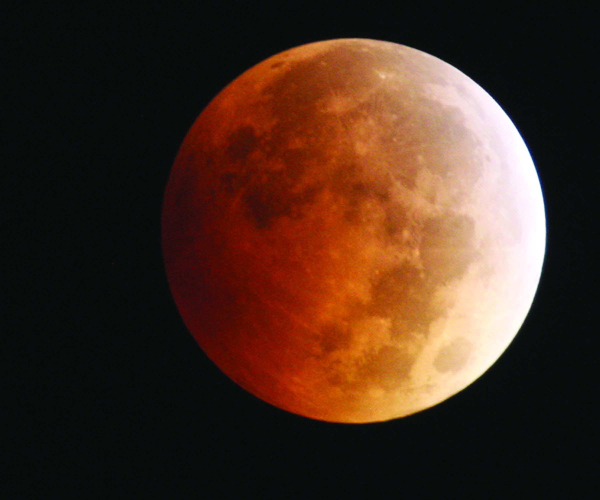 The moon takes on a reddish cast during a total lunar eclipse Oct. 8