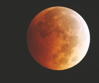 The moon takes on a reddish cast during a total lunar eclipse Oct. 8