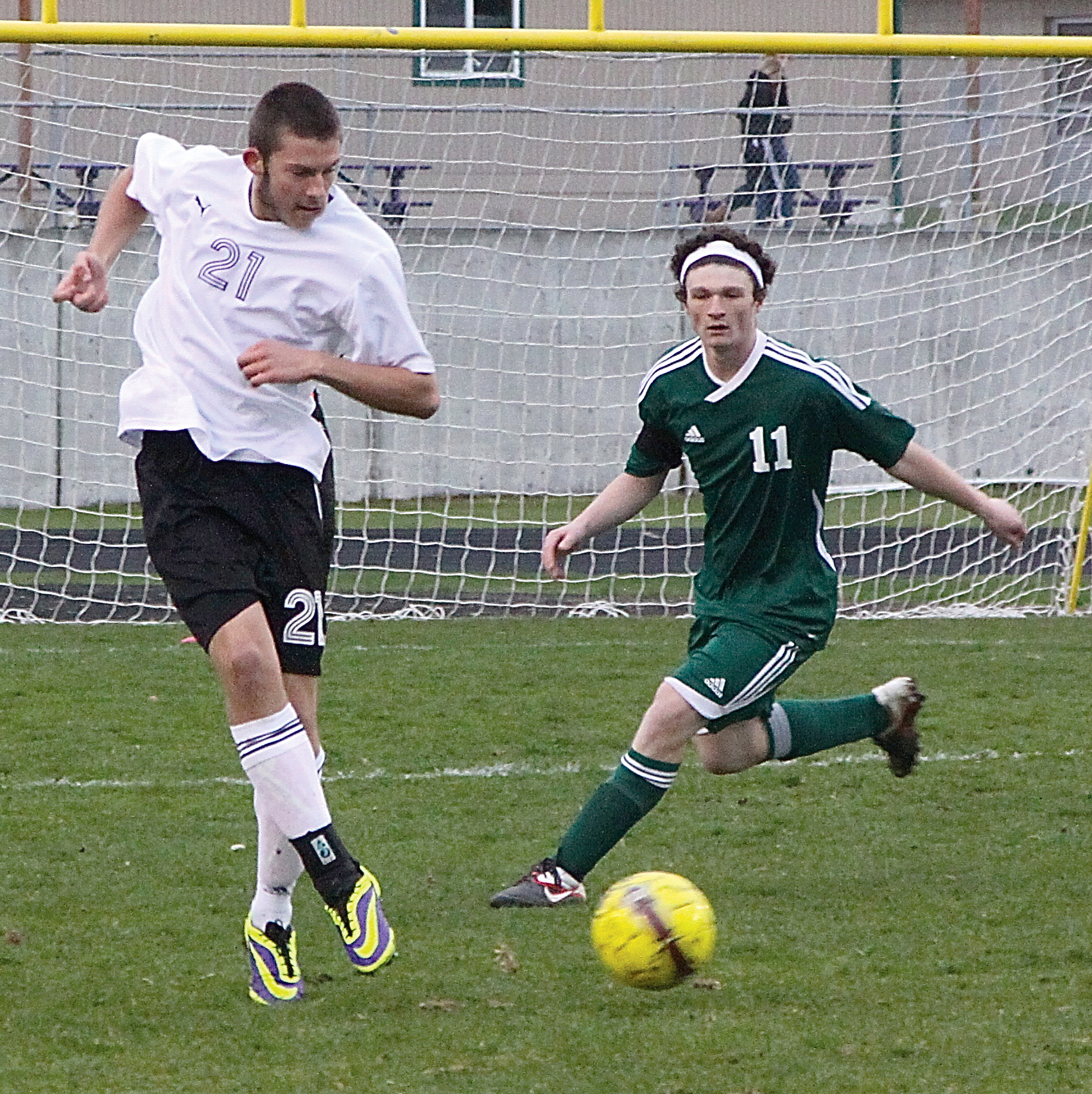 Sequim's Cameron Chase (21) kicks the ball against the defense of Port Angeles' Vincent Ioffrida (11) at Sequim High School last season. (Dave Logan/for Peninsula Daily News)