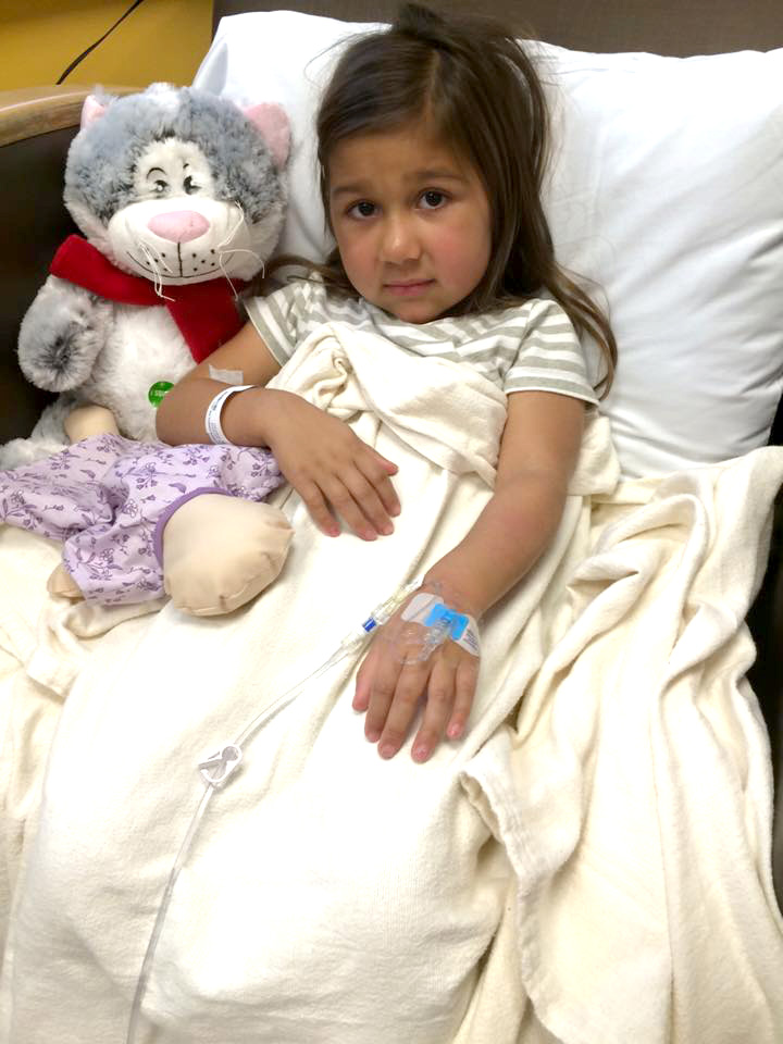 Five-year-old Hartlyn Flores receives an infusion in October. She has a reputation for approaching medical appointments armed with high heels
