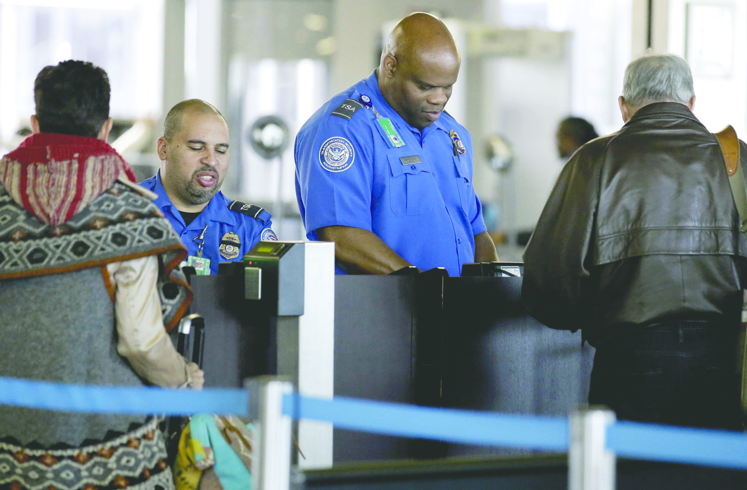 Transportation Security Administration agents check travelers identifications at a security check point area in Terminal 3 at O’Hare International Airport in Chicago in November. — The Associated Press ()
