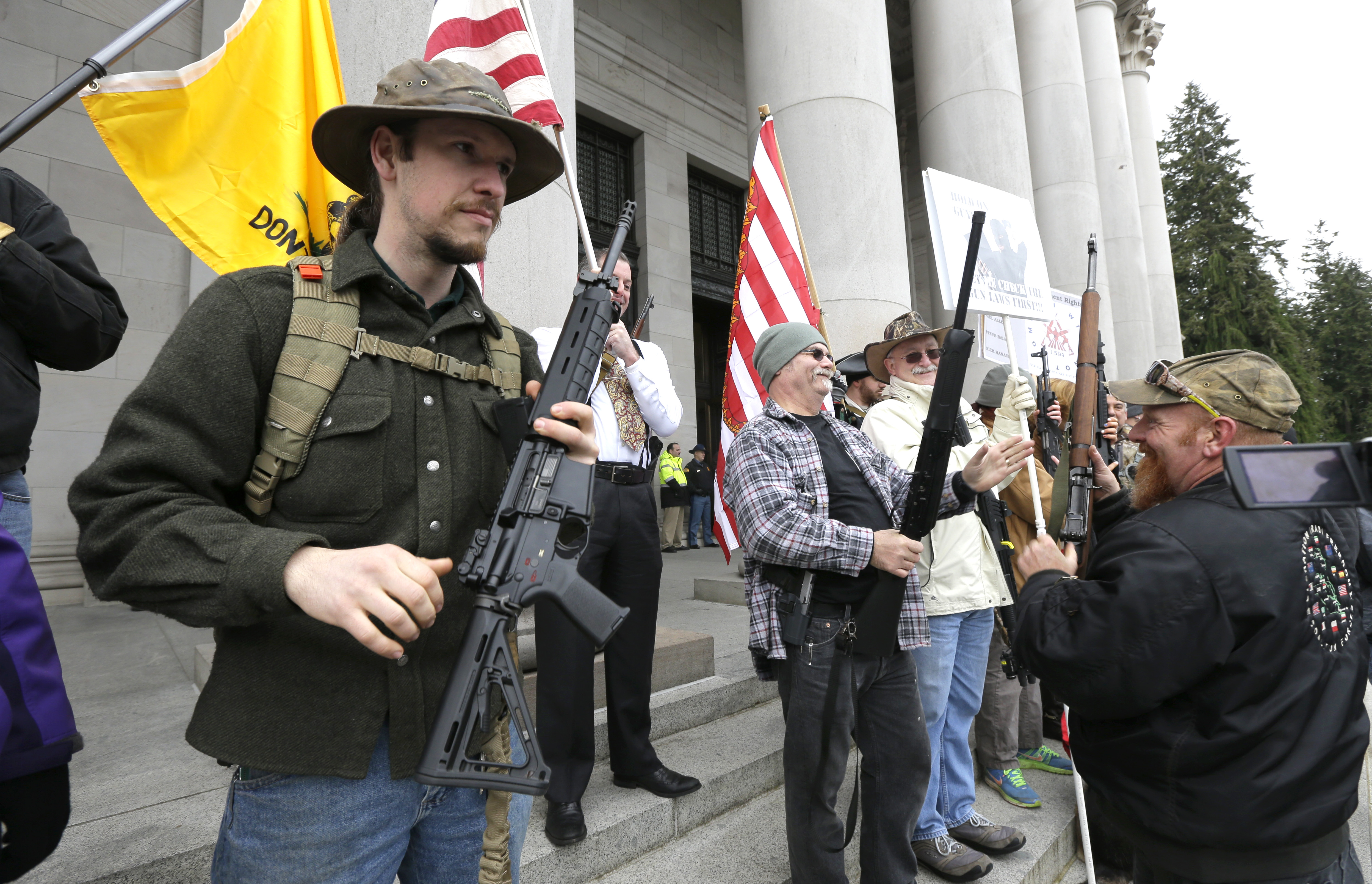 Gun owners display their weapons on the steps of the Legislative Building during a gun-rights rally on Thursday at the Capitol in Olympia. (The Associated Press)