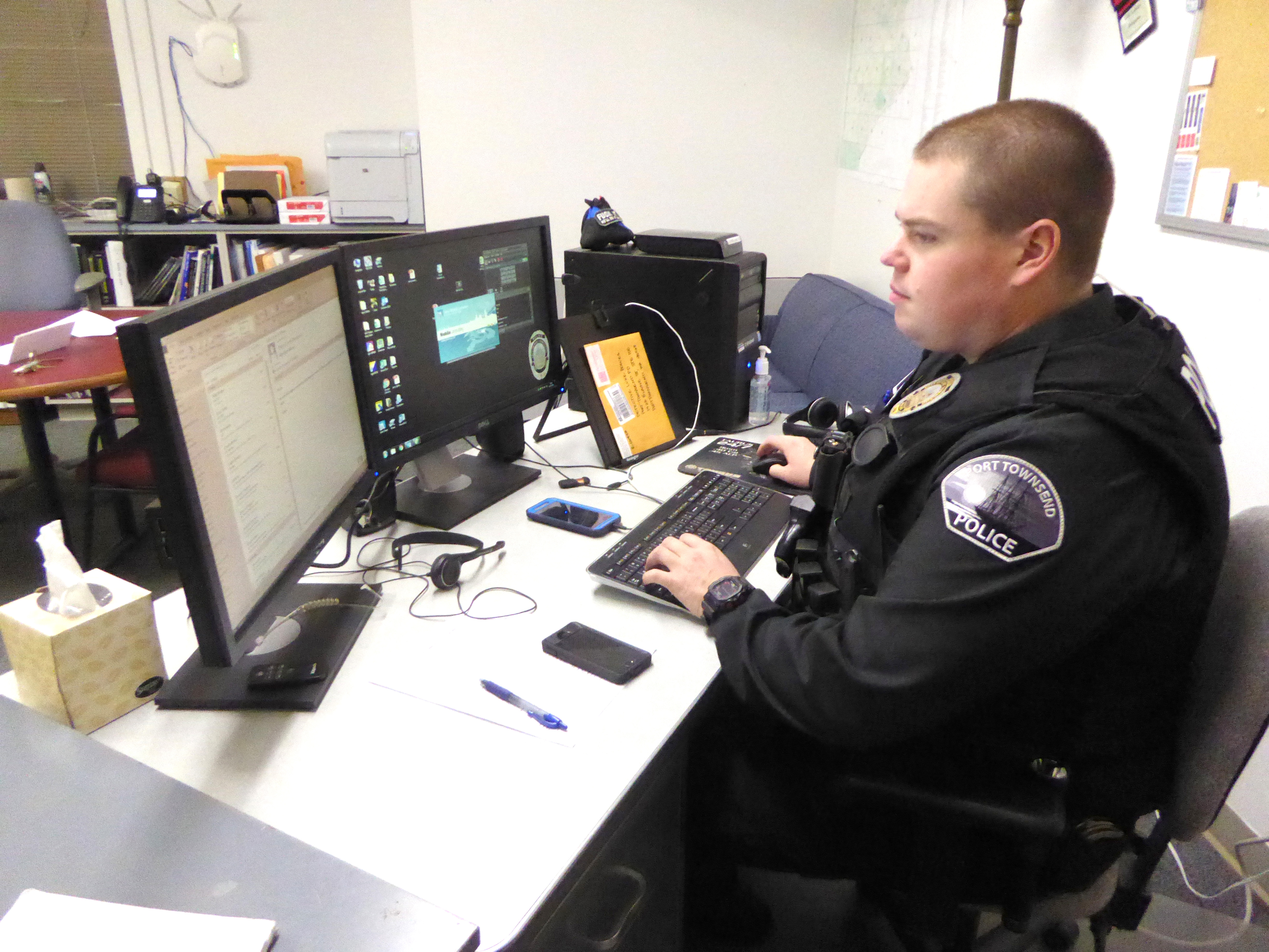 Port Townsend Police Detective Luke Bogues works the case of a stolen laptop Monday