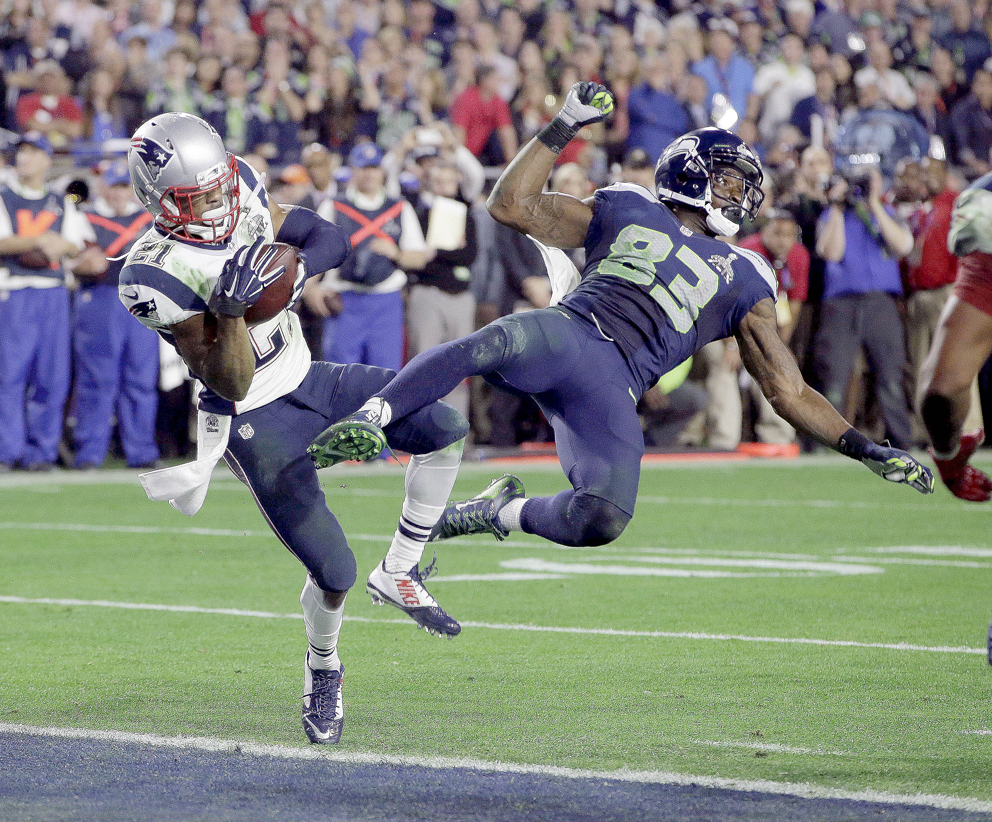 New England Patriots strong safety Malcolm Butler (21) intercepts a pass intended for Seattle Seahawks wide receiver Ricardo Lockette (83) during the closing two minutes of Sunday's Super Bowl XLIX game in Glendale