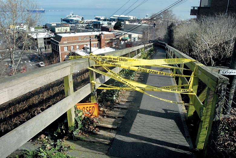 Crime tape marks the upper entrance to the ZigZag walkway that descends the bluff at Oak Street in downtown Port Angeles on Friday. (Keith Thorpe/Peninsula Daily News)