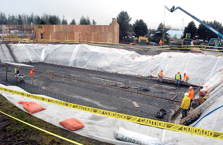 Construction crews work Friday on what will become a stormwater retention basin at the site of a new McDonald’s restaurant undergoing reconstruction between First and Front streets at Penn Street in Port Angeles. — Keith Thorpe/Peninsula Daily News ()
