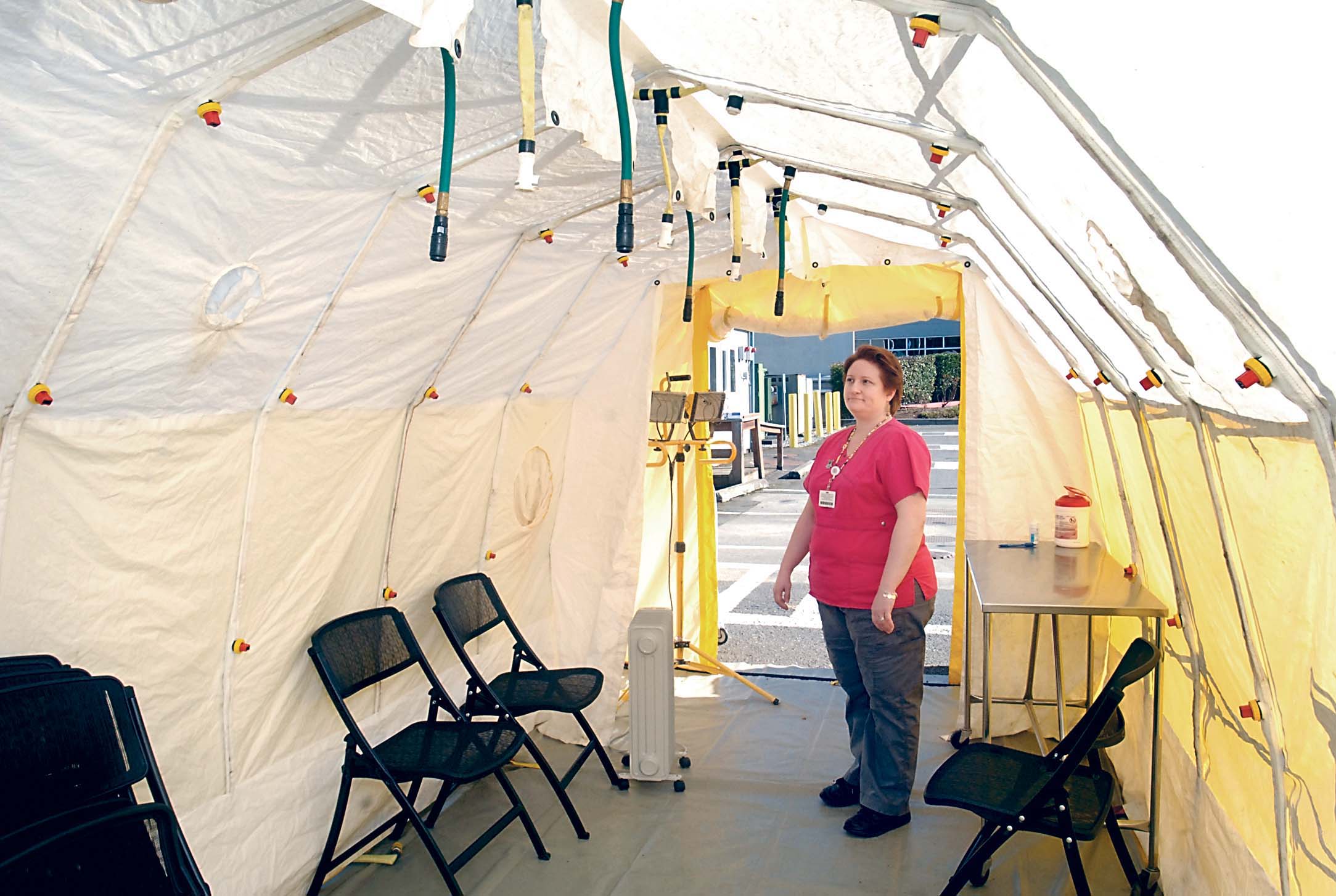 Olympic Medical Center lab assistant Deana Heimbigner looks over an isolation tent near the hospital's emergency room in Port Angeles on Wednesday. The tent is for temporarily quarantines of incoming patients with measles to prevent the disease from entering the hospital. (Keith Thorpe/Peninsula Daily News)
