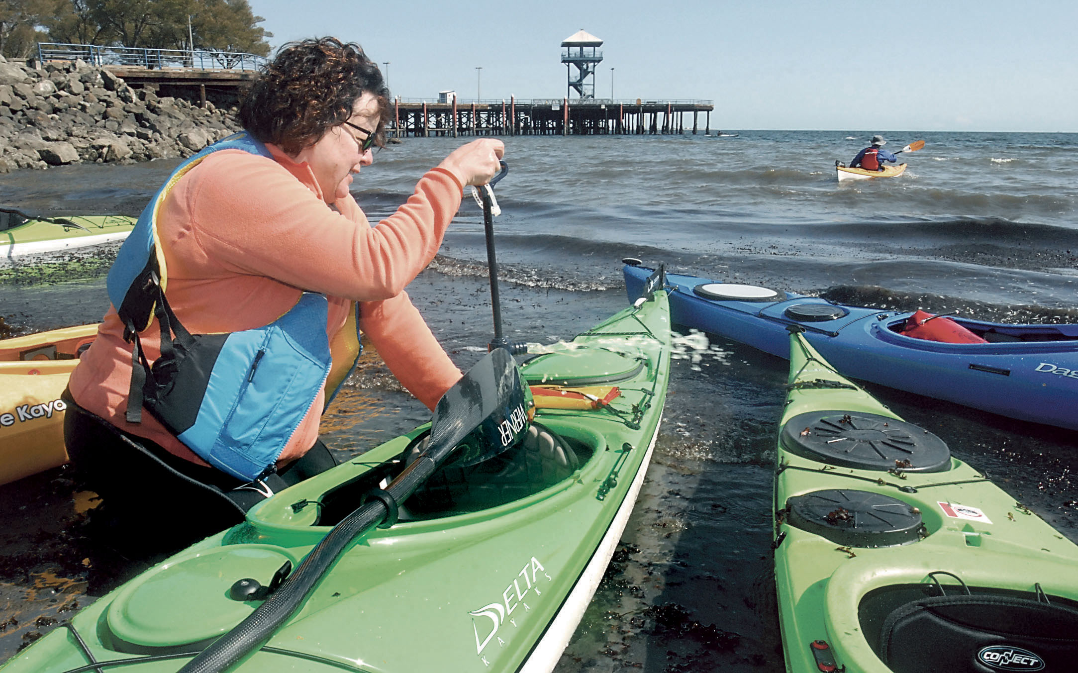 Susan Davis of Silverdale pump bilge water from a kayak at Hollywood Beach during last year’s equipment tryout session of the Port Angeles Kayak and Film Festival. — Keith Thorpe/Peninsula Daily News ()