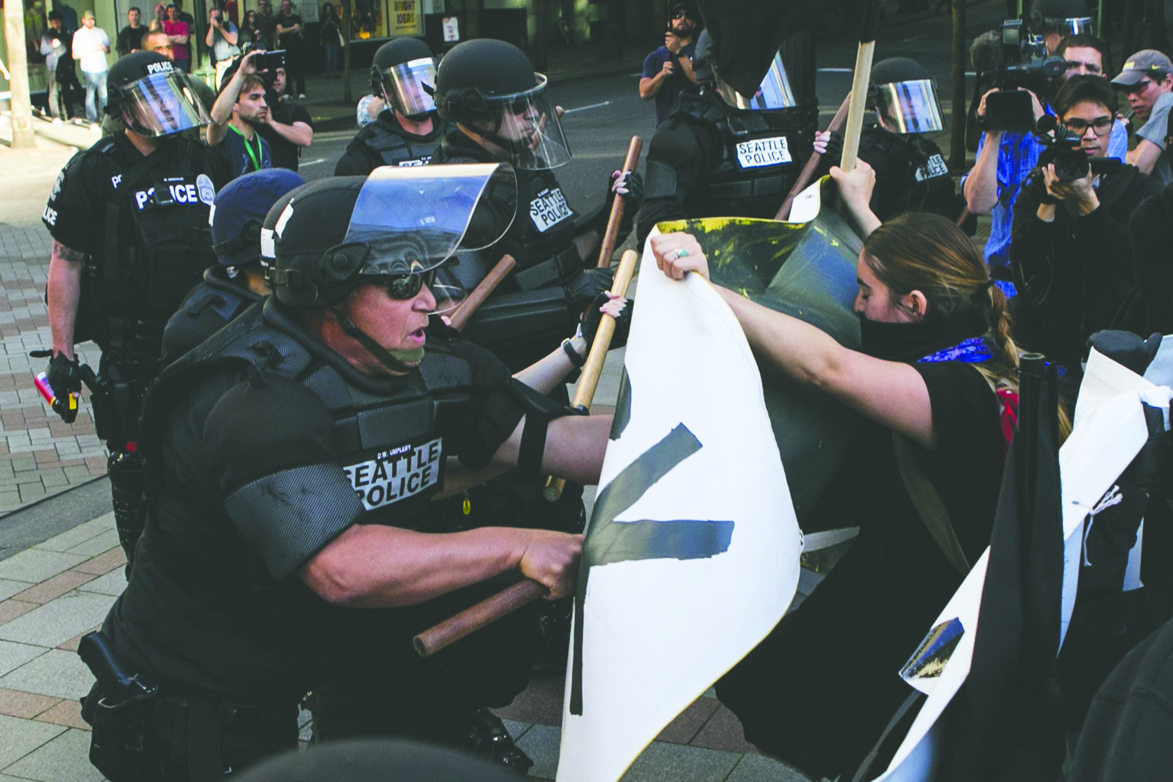 Protesters push the line that Seattle Police set up at the start of the march at Fourth Avenue and Pine during the annual May Day Anti-Capitalist protest and march Sunday in Seattle. — The Associated Press ()