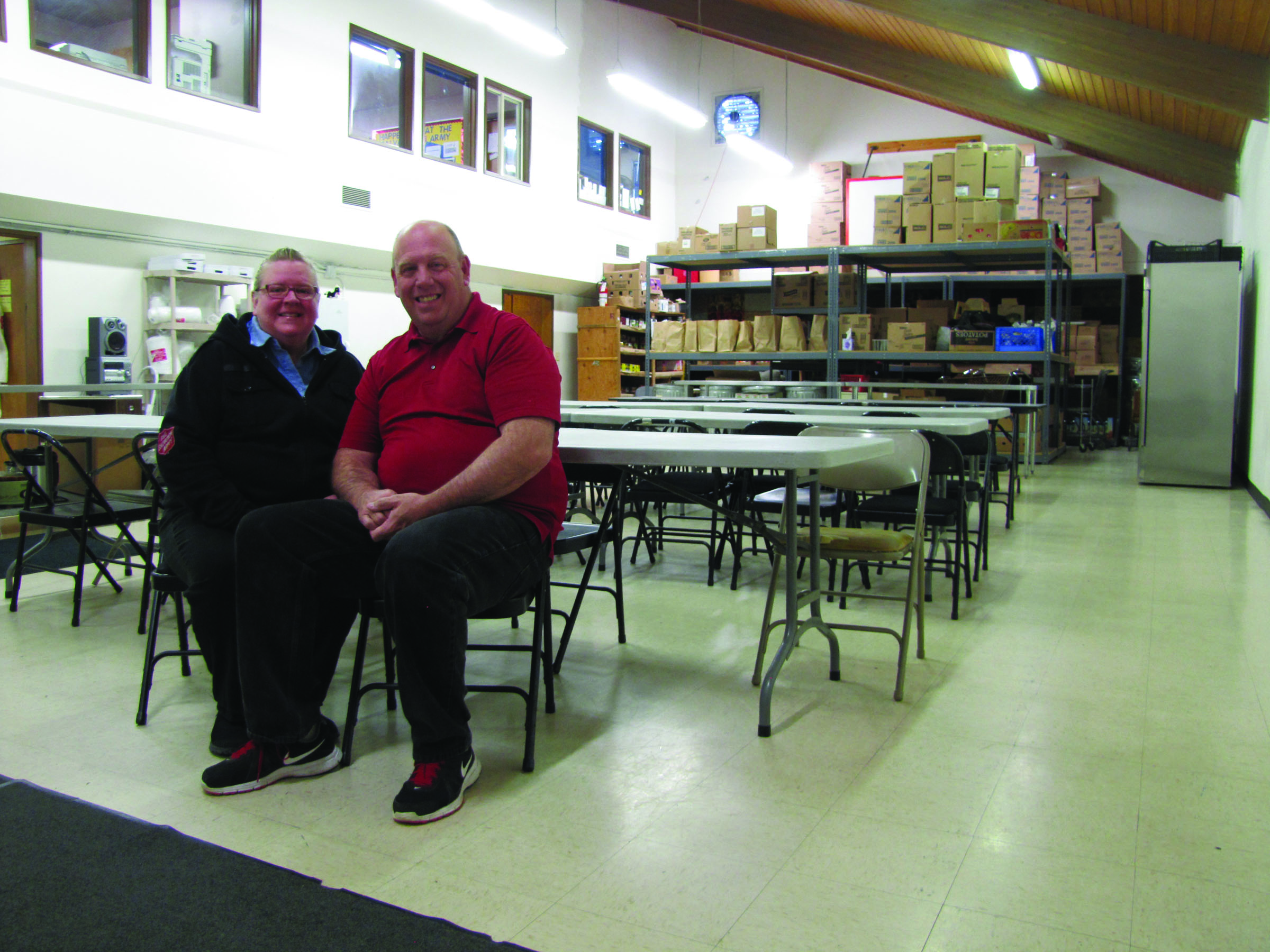 Salvation Army Majors Scott and Cherilee Ramsey at the existing Salvation Army dining room and food pantry. The Salvation Army is seeking funding to convert the dining room into an overnight shelter for the homeless and for the continued operations of the shelter. (Arwyn Rice/Peninsula Daily News)
