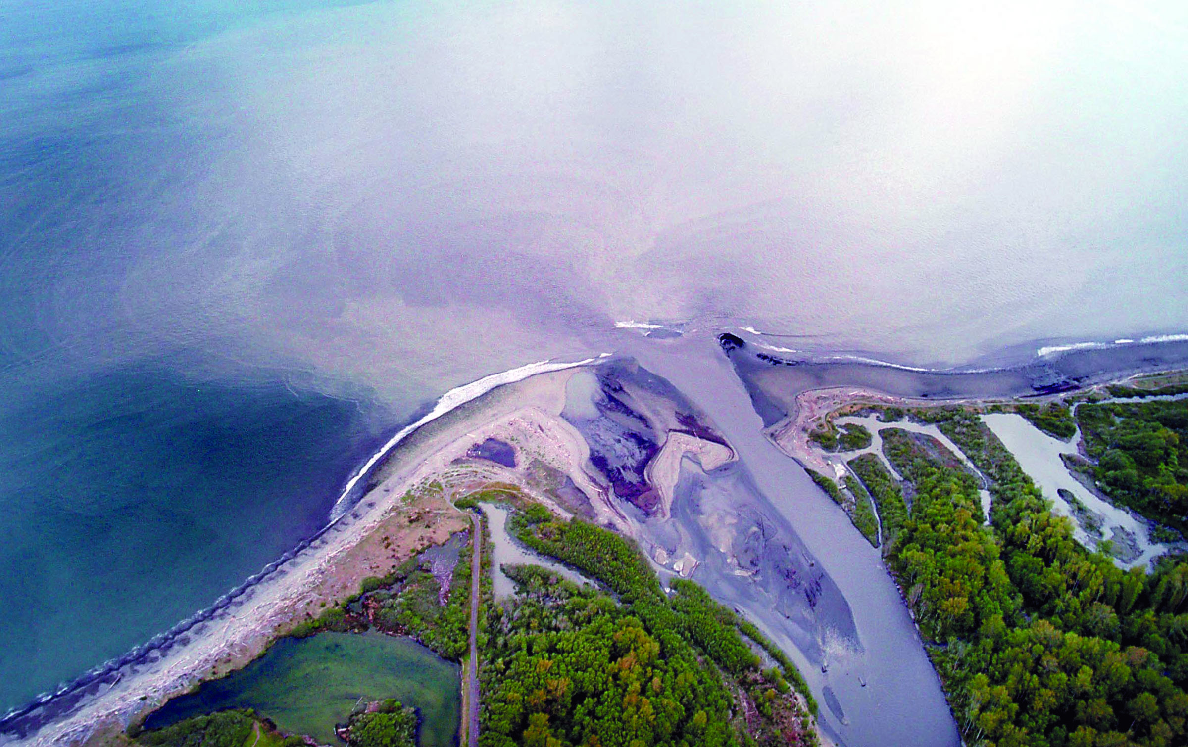 Sediment flows out of the mouth of the Elwha River into the Strait of Juan de Fuca in 2012 as the river cuts through nearly a century of silt. An exhibit at Port Angeles Library will look at the entire timelime of the river from the dams’ removals to restoration efforts along old lake beds. — Keith Thorpe/Peninsula Daily News ()