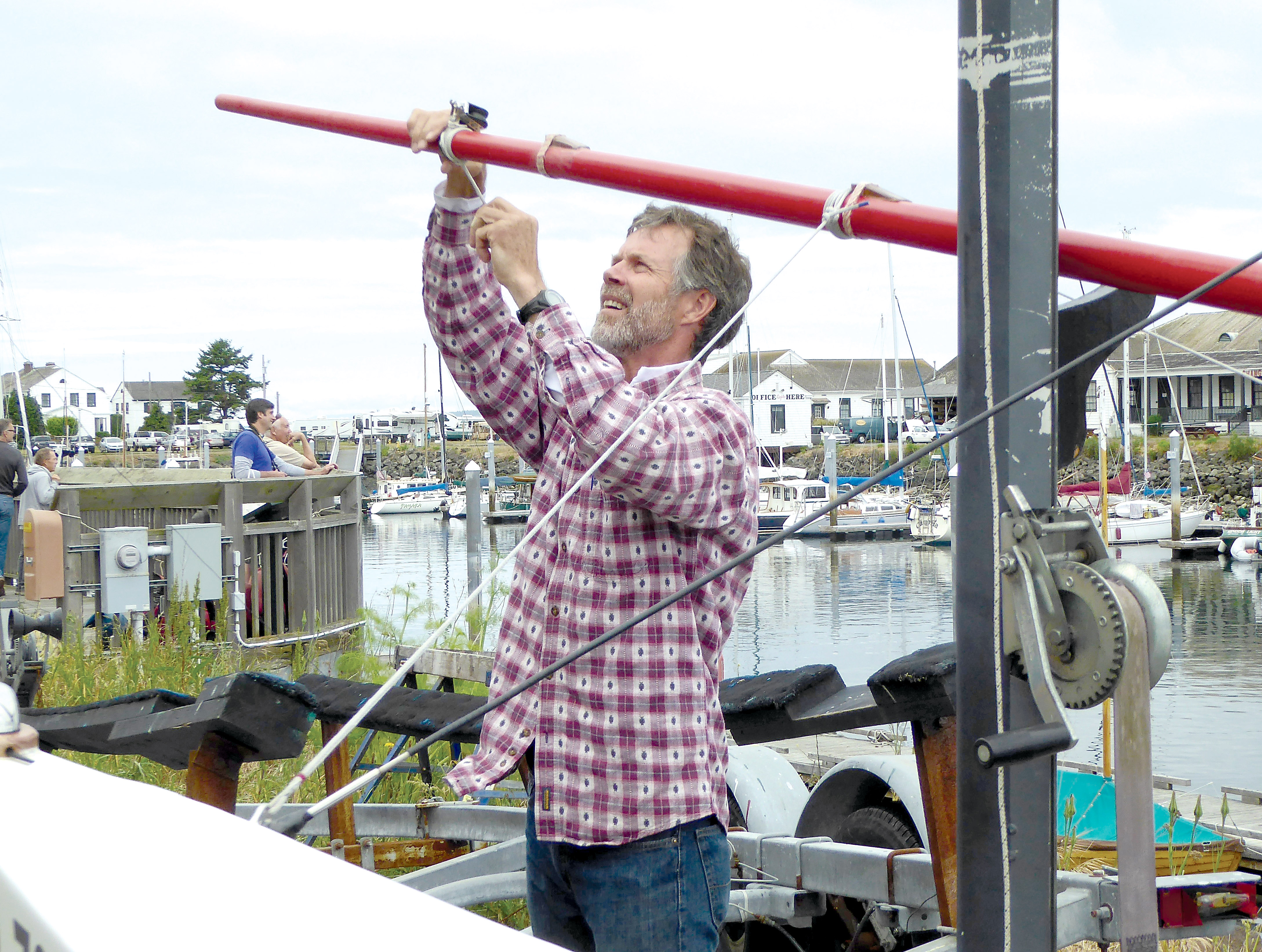 Piper Dunlap of Port Townsend fixes a mast Wednesday in preparation for the Race to Alaska. — Charlie Bermant/Peninsula Daily News ()