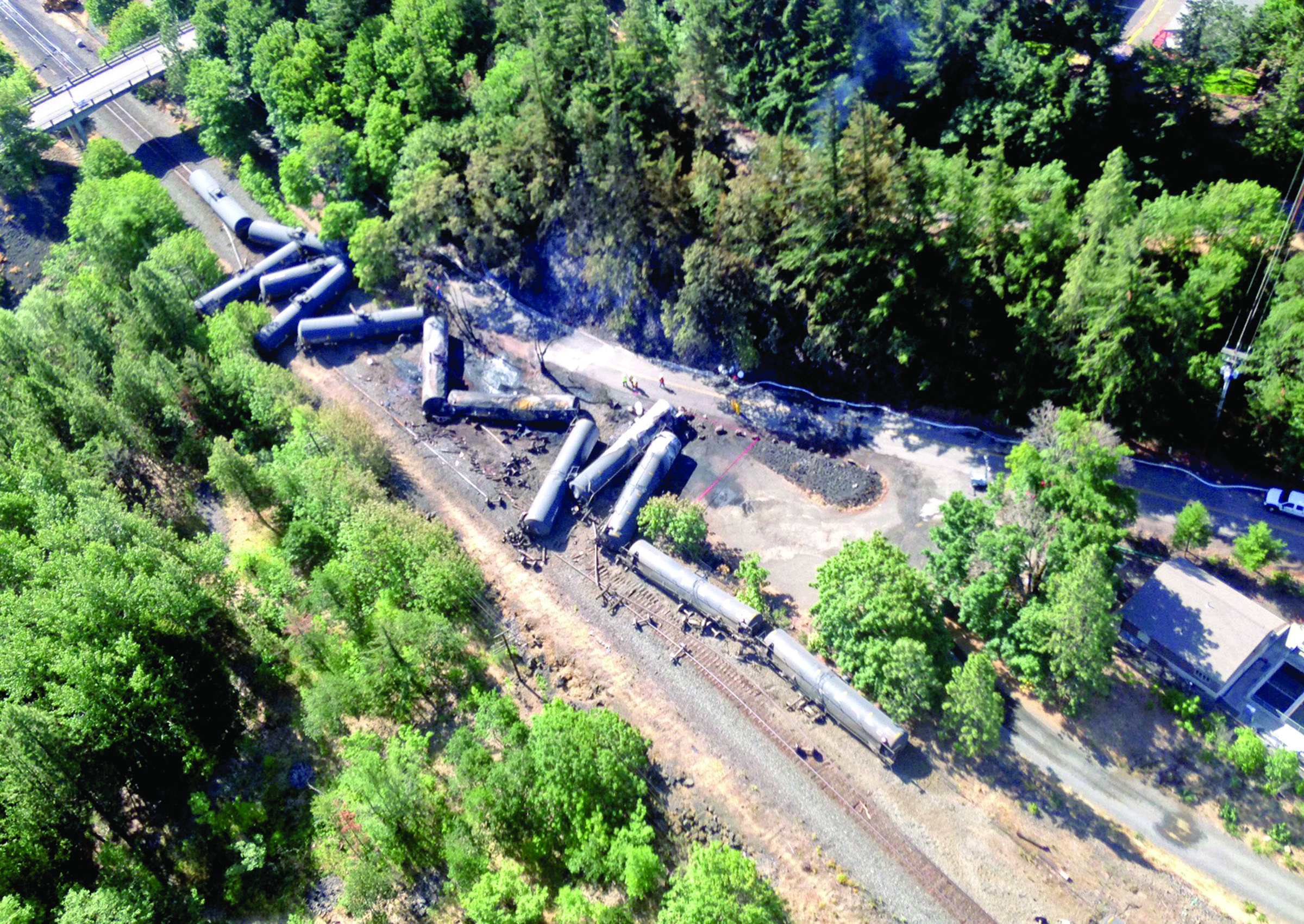 This aerial view provided by the Washington State Department of Ecology shows scattered and burned oil tank cars Saturday after the train derailed and burned near Mosier
