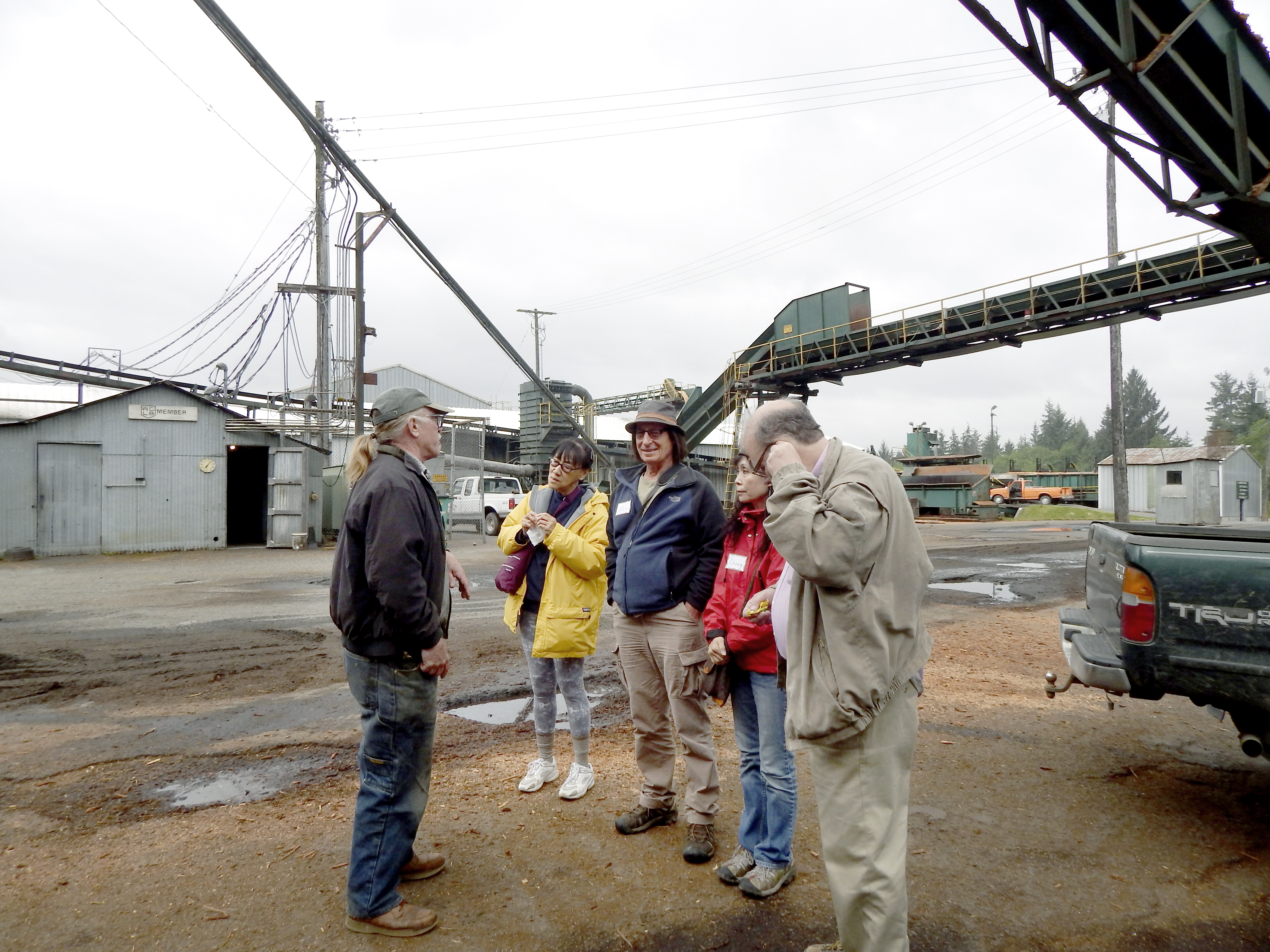 Joe Seymour speaks to a group of tourists at Allen Logging Co. near Forks during a Forks Chamber of Commerce Logging & Mill tour. — Christi Baron/Forks Forum ()