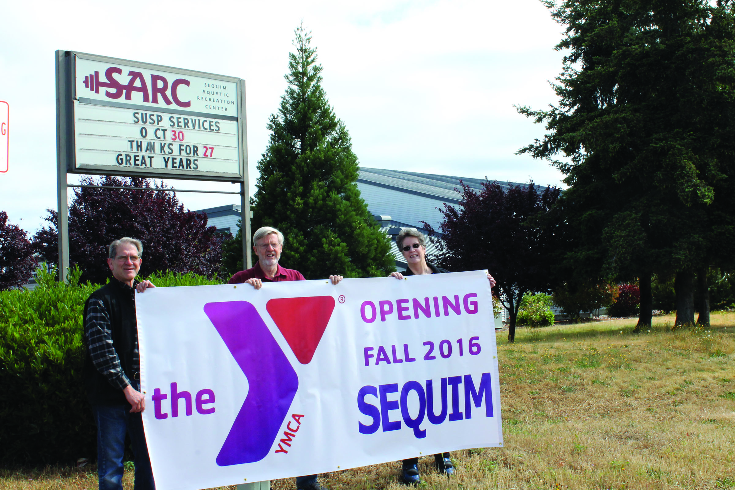 Holding a banner about the expected fall opening of the Sequim Y are