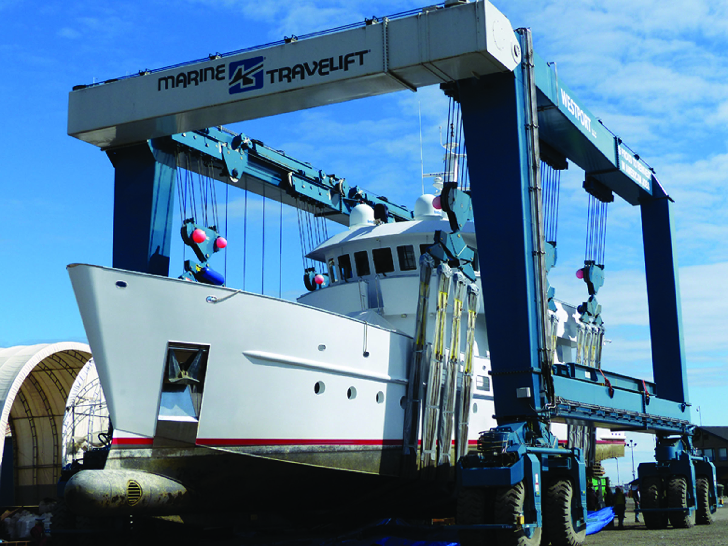 The Surfbird is suspended in a borrowed TraveLift at Platypus Marine in Port Angeles Harbor. — David G. Sellars/for Peninsula Daily News ()