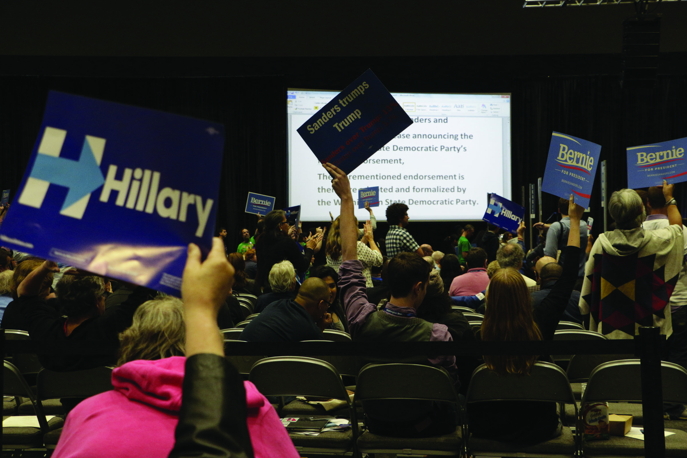 Democrats wave signs at the state Democratic convention in Tacoma on Saturday. State Democrats met to pass a party platform and finish electing delegates to the national convention this summer. — The Associated Press ()
