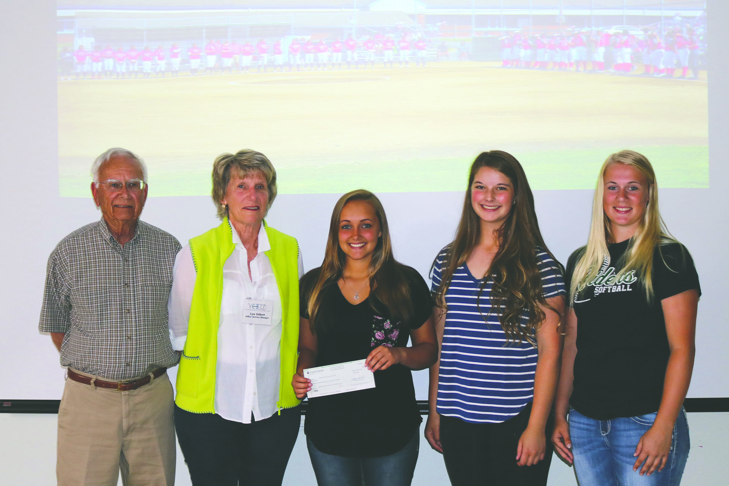 A donation check for $724 was presented to Volunteer Hospice of Clallam County. From left are Hospice representatives David and Lyn Gilbert and Port Angeles High School girls softball varsity team members