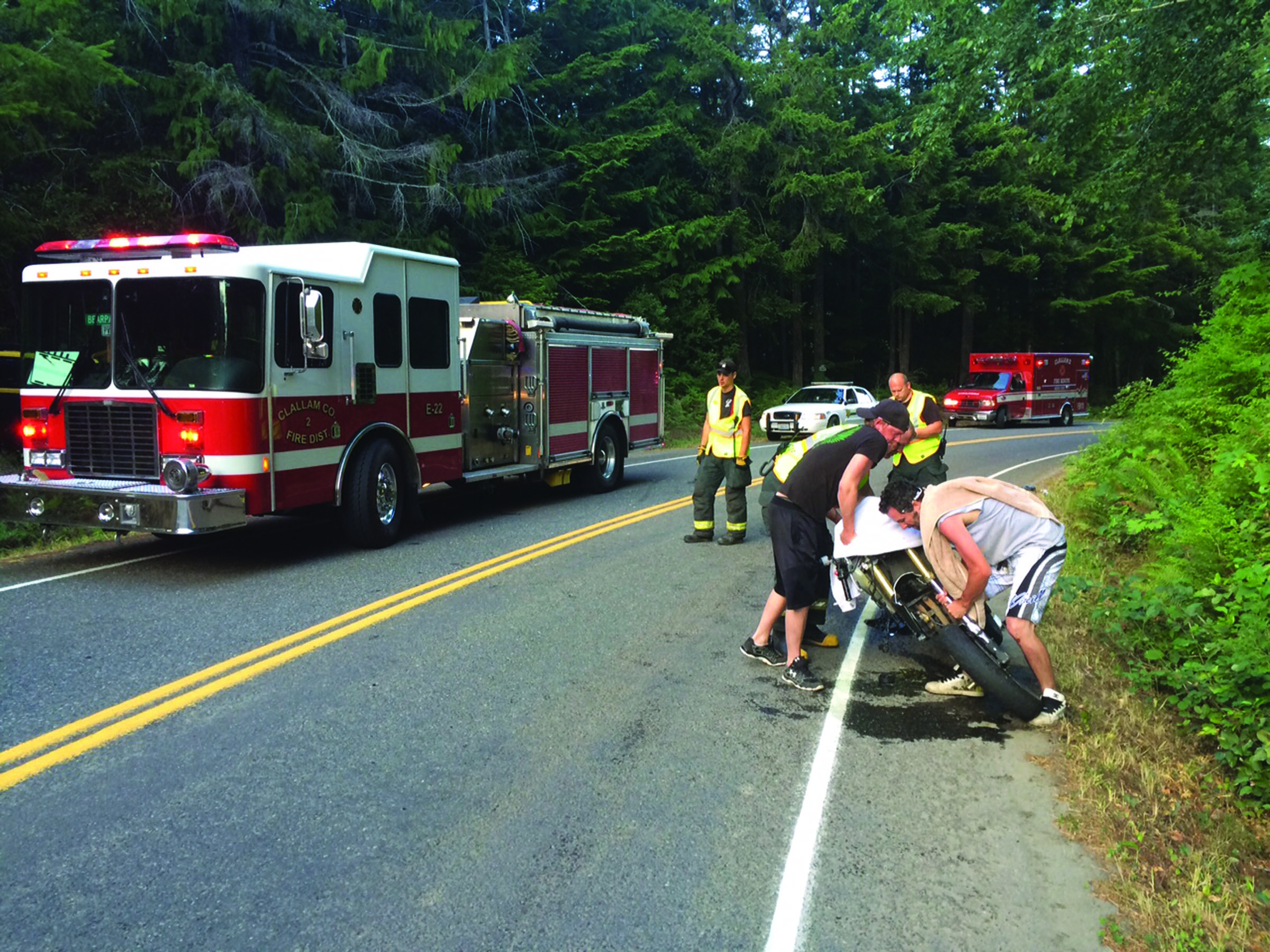 A group of men right a Suzuki motorcycle after it collided with a Dodge van on East Beach Road on Saturday at about 6:30 p.m. The motorcyclist was transported to Olympic Medical Center in Port Angeles with nonlife-threatening injuries. Clallam County Fire District No. 2 responded to the crash. No other injuries were reported. — Clallam County Fire District No. 2 ()