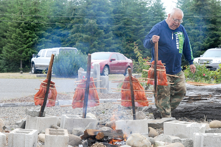 Quileute tribal elder Tommy Jackson prepares salmon for Saturday's fish bake fundraiser at the Kitla Center
