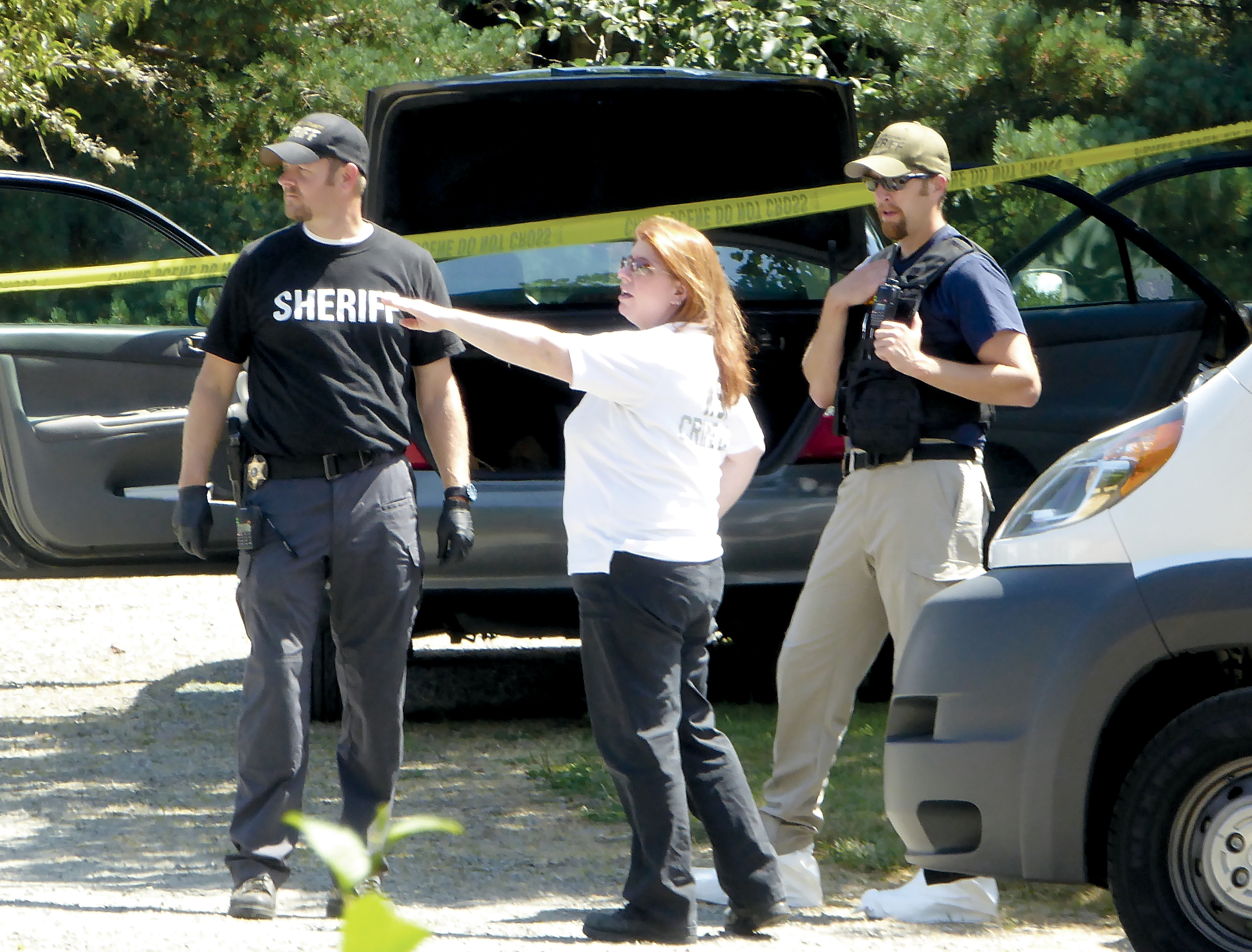 State Patrol forensic scientist Sara Trejo meets with Jefferson County sheriff’s Detectives Ryan Menday
