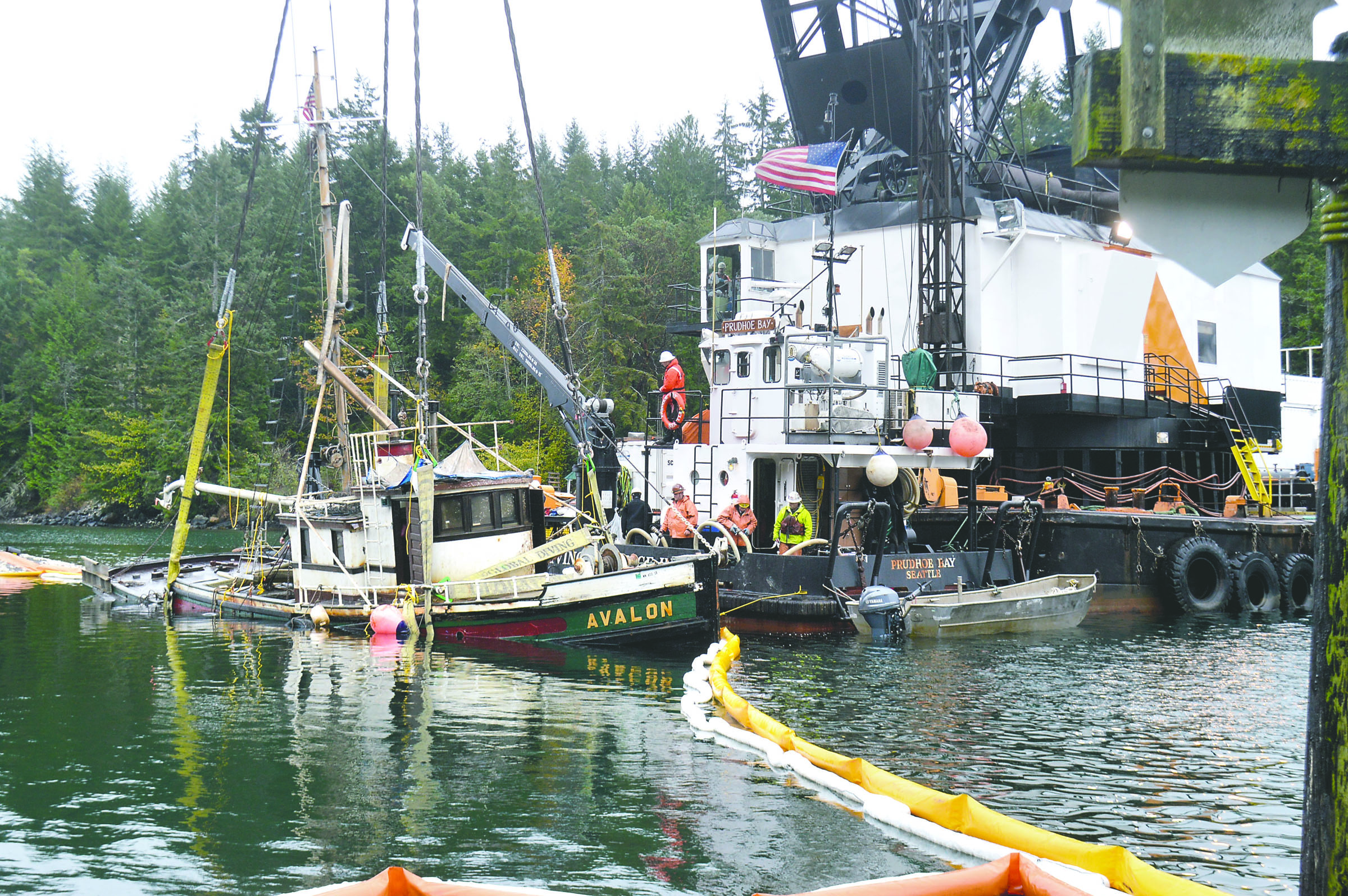 Workers with Global Diving & Salvage pull the 65-foot pleasure craft Avalon out of Pleasant Harbor in Brinnon after it sank in September. — State Department of Natural Resources